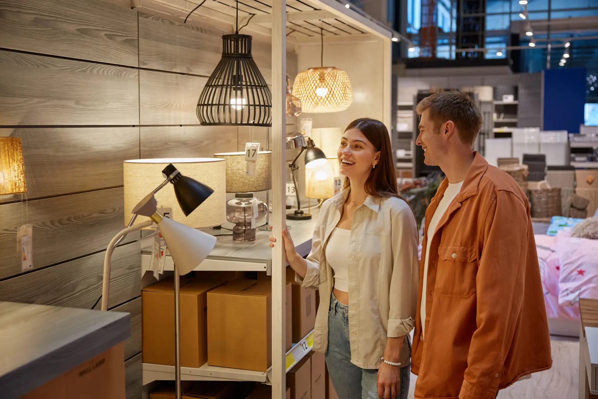 Couple shopping and looking at chandeliers but a retailer has no idea why the shoppers are in their store or what they are learning about the products
