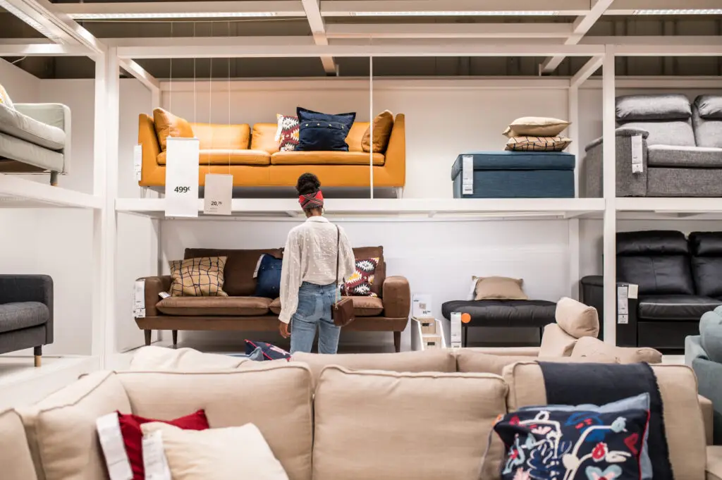female customer choosing furniture in shopping center but pricing doesnt match what she saw online