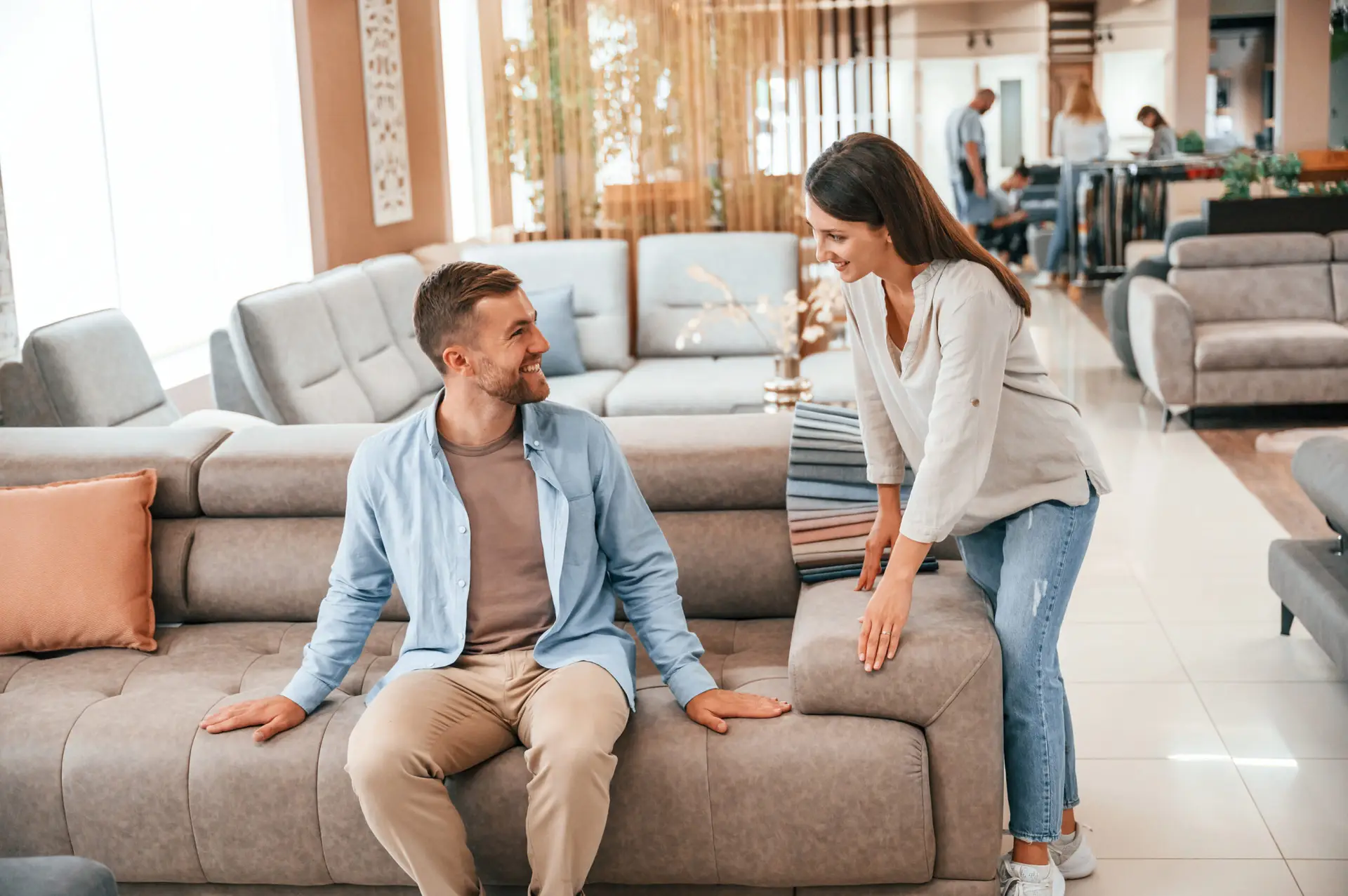 Image of male shopper touching the couch and interacting with a RSA